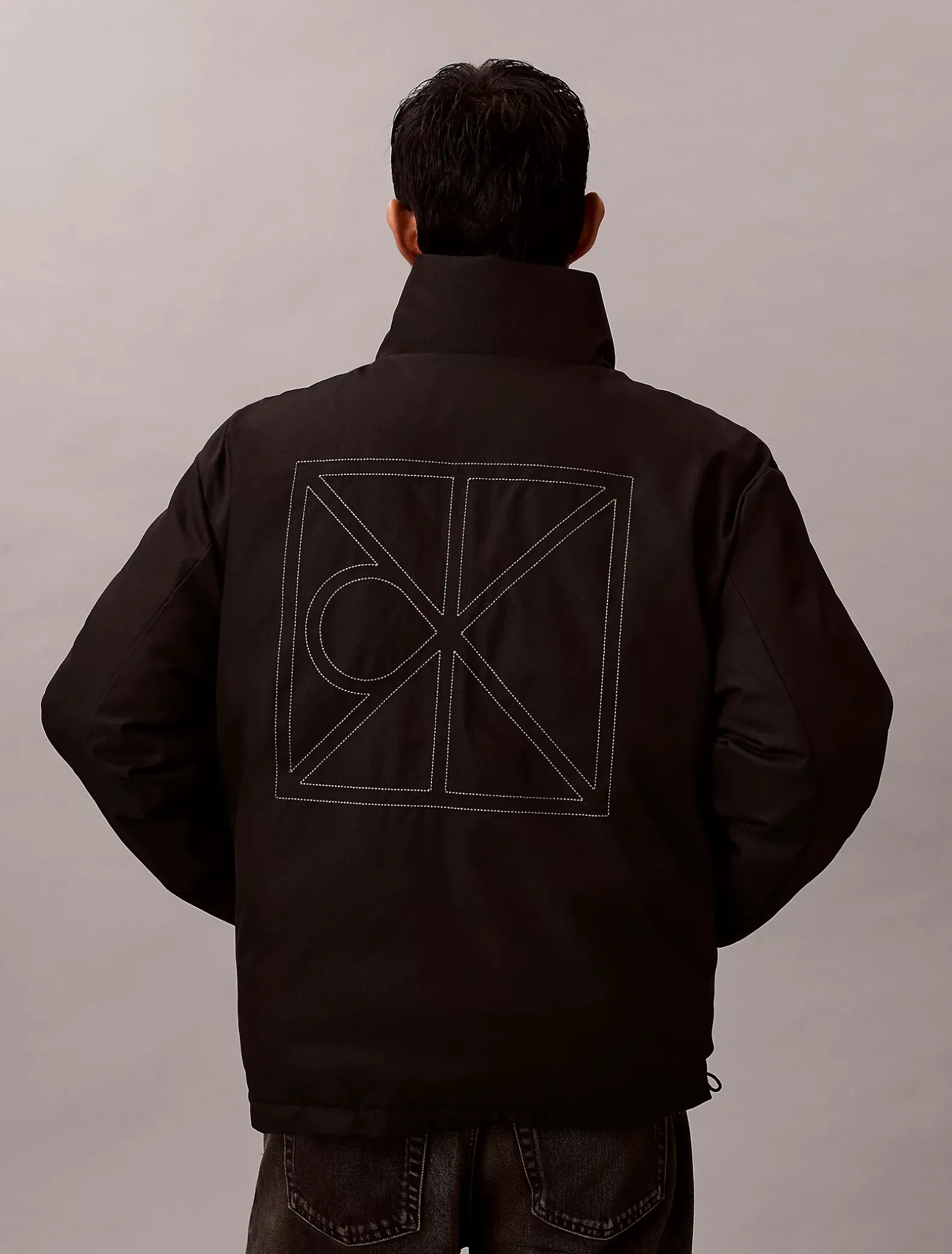 Omkeerbaar pufferjack met all-over embleem logo